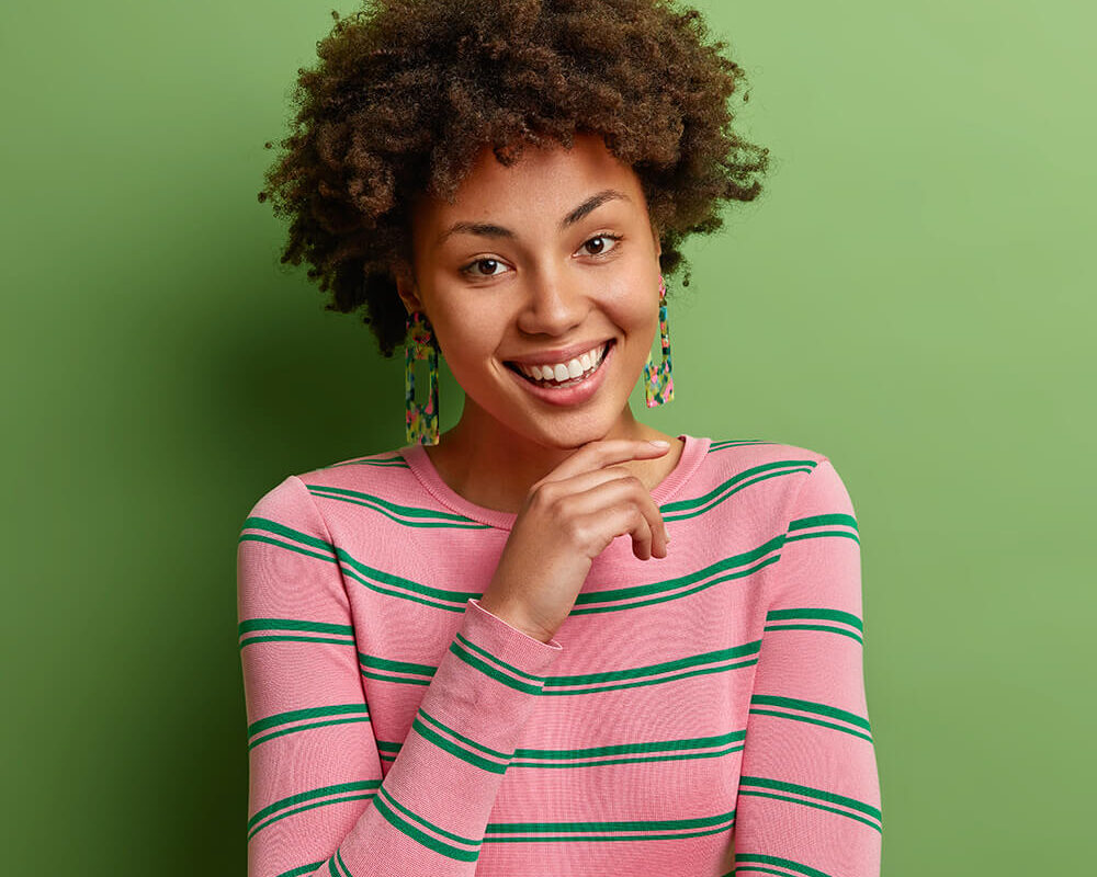 portrait-of-good-looking-curly-haired-woman-keeps-ZDL9EAG.jpg