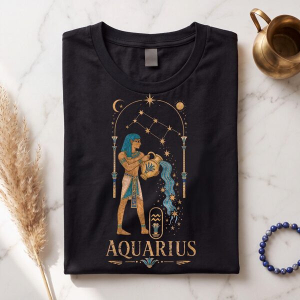 Black Aquarius Ancient Egypt zodiac T-shirt folded flat on white marble with a brass jug