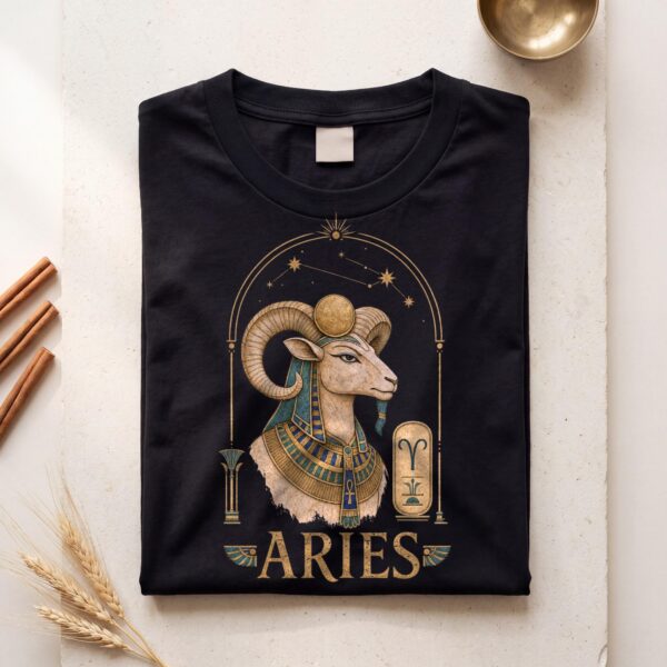 Black Aries Ancient Egypt zodiac T-shirt folded flat on cream plaster with cinnamon sticks