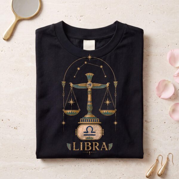Black Libra Ancient Egypt zodiac T-shirt folded flat on pale marble with rose petals and a gold mirror