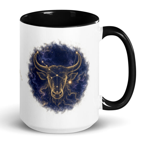 White ceramic mug with black interior and handle, showing the enlarged gold and navy Taurus constellation orb
