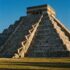 El Castillo, the Temple of Kukulcán at Chichén Itzá in Yucatán, Mexico, seen from the northwest in late-afternoon equinox light. The steep grey limestone pyramid with nine stepped terraces and a small temple on top. Down the edge of its north stairwa