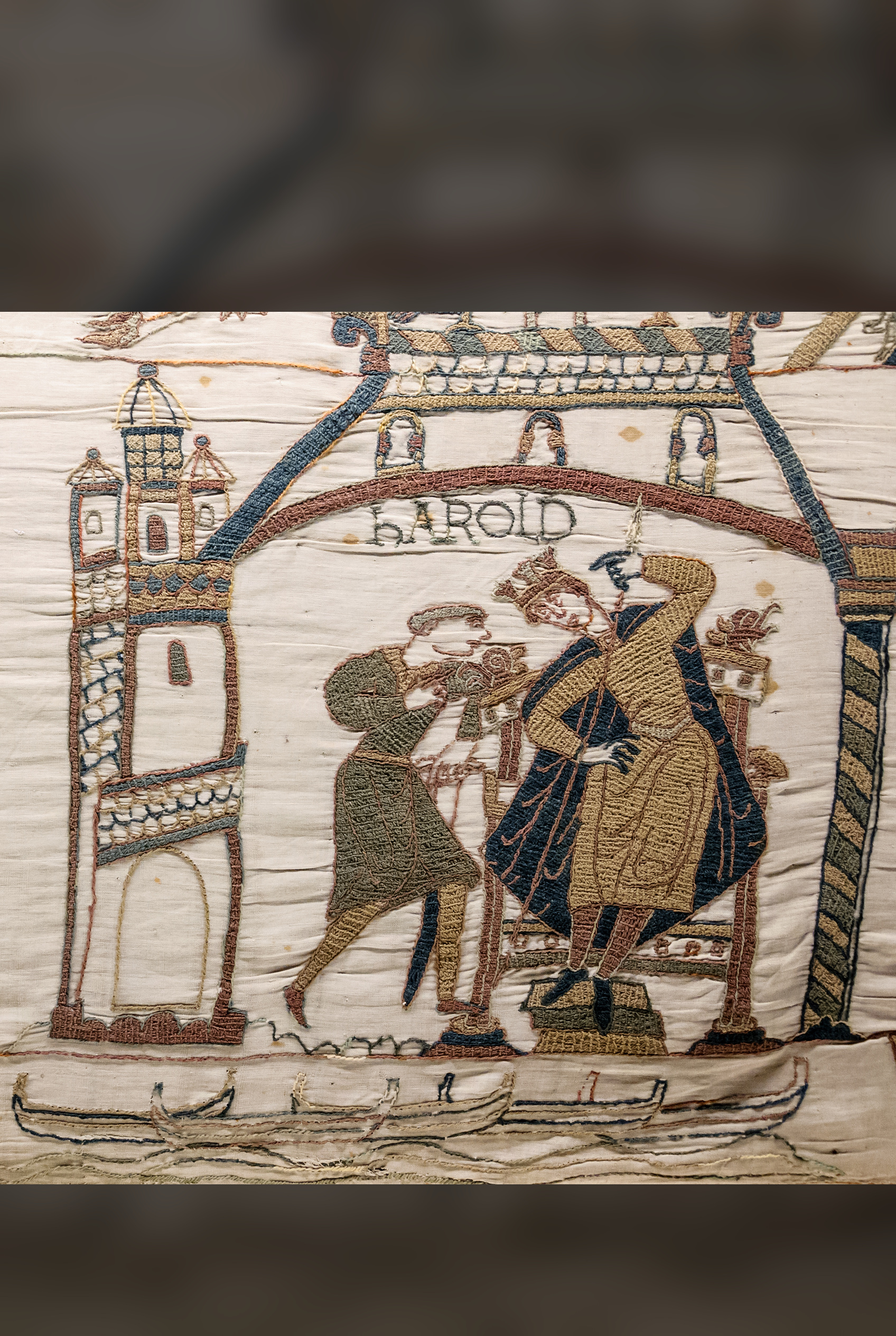 Ghostly outline ships in the border beneath a seated king