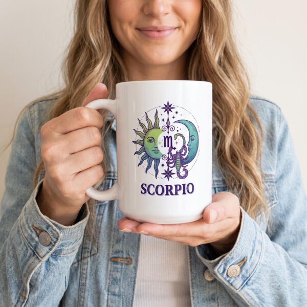 A person holding the personalized Scorpio Day & Night mug with a sun-and-moon Scorpio design
