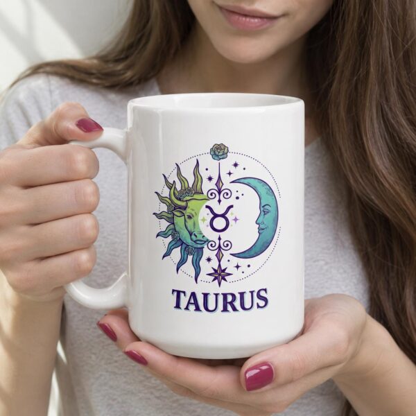 A person holding the personalized Taurus Day & Night mug with a sun-and-moon Taurus design