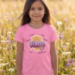 Virgo Aries: Street Sign × Scorpio: Street Sign Tail Badge Youth Classic Tee (Gildan 5000B), White, Light Blue, Sport Grey in use: A sunny wildflower meadow with tall golden grasses and daisies, soft late-afternoon light, gentle and dreamy.